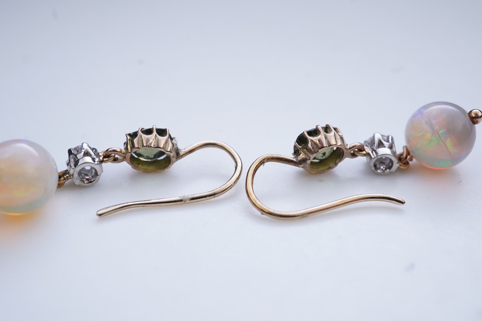 A pair of opal, green zircon and diamond earrings